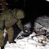 This image made from undated video provided by the Russian Defense Ministry Press Service on Wednesday, Dec. 31, 2025, shows a man in camouflage standing by a downed drone at an undisclosed location that it said was one of the Ukrainian drones involved in an alleged attack on a residence of President Vladimir Putin this week