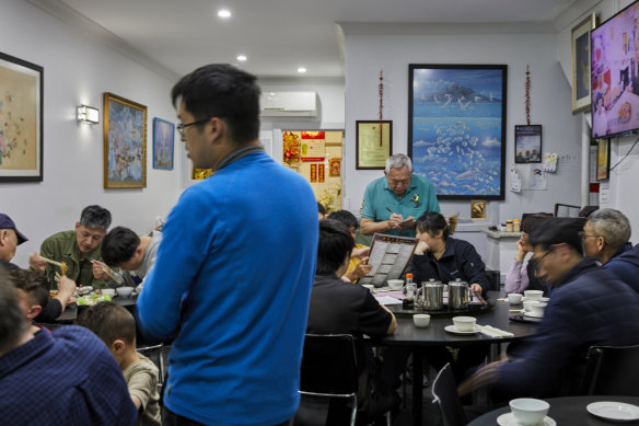 Anthony Kwok (standing, at rear) taking orders.