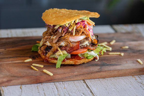A crisp fried arepa split into two
discs hosts a variety of burger fillings.