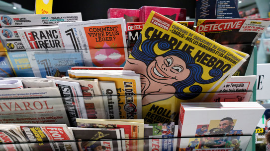 The front page of “Charlie  Hebdo”  reading “Mollahs go back from where you come” is seen in a newsstand on January 5. The weekly published dozens of cartoons on the same day ridiculing the highest religious and political figure in the Islamic republic.