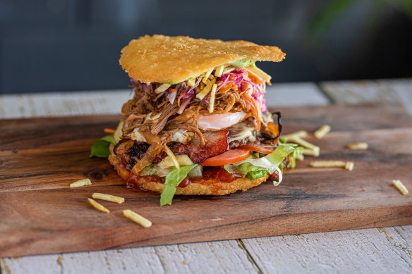 A crisp fried arepa split into two
discs hosts a variety of burger fillings. 