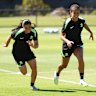 Alex Chidiac warms up with Mary Fowler during Matildas training in Perth on Saturday.