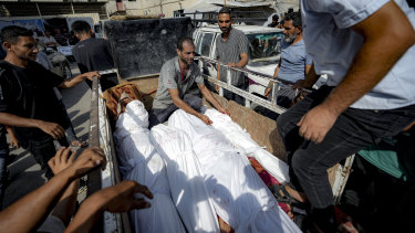Palestinians gather near the bodies of relatives killed in the Israeli bombardment of Deir al-Balah.