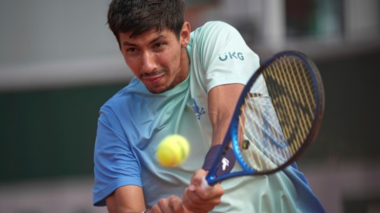 Australia’s Alexei Popyrin hits a backhand against Japan’s Yoshihito Nishioka.
