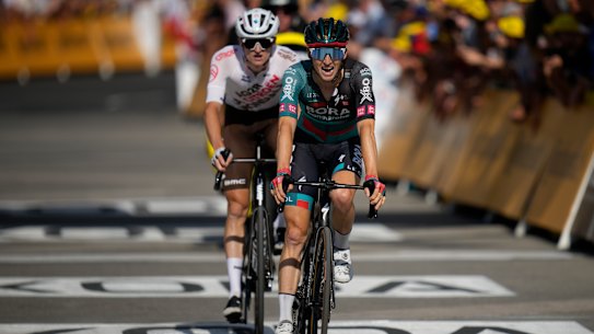 Jai Hindley crosses the line in stage 14.