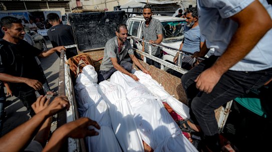 Palestinians gather near the bodies of relatives killed in the Israeli bombardment of Deir al-Balah.
