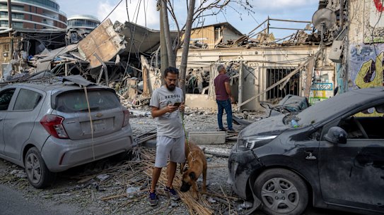 Israelis inspect the rubble of a Tev Aviv building a day after it was hit by a rocket.