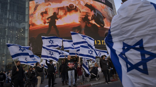 Right wing activists wave Israeli flags during a protest against Israel’s Prime Minister Naftali Bennett, following a recent wave of violence, in Tel Aviv, Israel, on Wednesday.