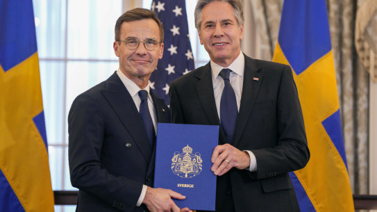 US Secretary of State Antony Blinken, right, and Swedish Prime Minister Ulf Kristersson hold Sweden’s NATO Instruments of Accession at the US State Department in Washington.