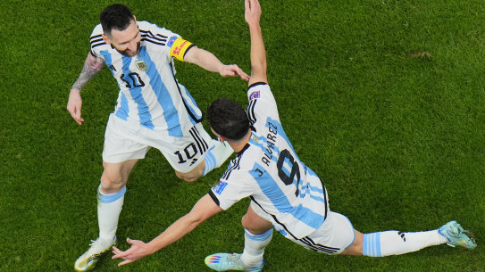 Lionel Messi and Julian Alvarez celebrate a goal.