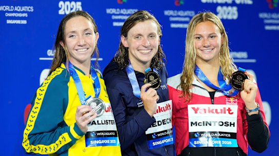 800m freestyle gold medallist Katie Ledecky of the United States, centre, flanked by silver medallist Lani Pallister of Australia, left, and bronze medallist Summer McIntosh of Canada, right.