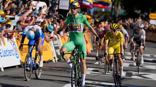 wearing the best sprinter’s green jersey, celebrates as he crosses the finish line ahead of second placed Australia’s Michael Matthews, left and third placed Slovenia’s Tadej Pogacar, , wearing the overall leader’s yellow jersey, during the eighth stage of the Tour de France cycling race over 186.5 kilometers (115.9 miles) with start in Dole, France, and finish in Lausanne, Switzerland, Saturday, July 9, 2022. (AP Photo/Thibault Camus)