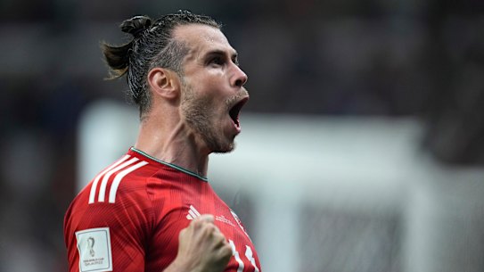 Gareth Bale celebrates the late penalty which earned Wales a point against the US.