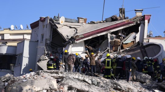 A member of rescue team asking people to be silent for them to hear the people under the debris of a collapsed building, in Ghaziantep, Turkey.