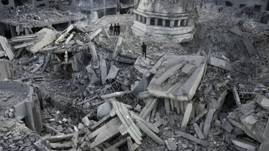 Palestinians inspect the rubble of the Yassin Mosque destroyed after it was hit by an Israeli airstrike at Shati refugee camp in Gaza City, early Monday, Oct. 9, 2023. Israel’s military battled to drive Hamas fighters out of southern towns and seal its borders Monday as it pounded the Gaza Strip. (AP Photo/Adel Hana)