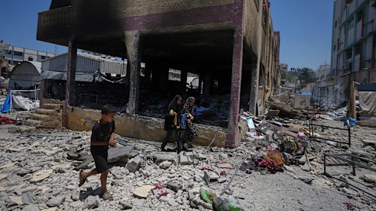 Palestinians survey the destruction at a school used as a shelter after it was struck by an Israeli airstrike in Gaza City.