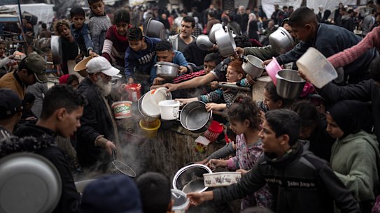 Palestinians line up for a free meal in Rafah, Gaza Strip, on Thursday.