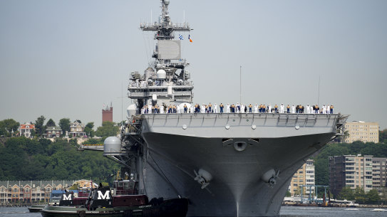 Sailors and military service personnel arrive on the USS Wasp amphibious assault ship on the Hudson River during fleet week in New York.