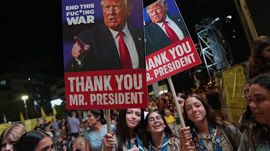 Holding up signs with images depicting the U.S. President Donald Trump, people take part in a rally in support of hostages kidnapped by Hamas, at a plaza known as hostages square in Tel Aviv, Israel.
