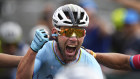 Mark Cavendish celebrates after crossing the finish line to win a record 35th Tour de France.