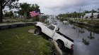 A truck sits halfway into a canal after Hurricane Idalia hit the coast of Florida.