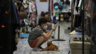 A vendor waits for customers in a Beijing store. China’s growth challenges are both cyclical and secular.