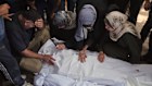 Mourners bid farewell to relatives killed by an Israeli airstrike that struck a school being used as a shelter in Gaza City.