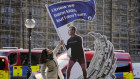 Unfriendly fire. An anti-Facebook campaigner adjusts an installation outside parliament in Westminster in London.