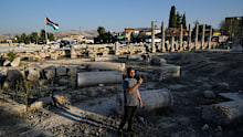 A Palestinian visitor takes a photo at the Roman historical site in the West Bank town of Sebastia Thursday, Nov. 20, 2025. 