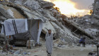 Palestinians walk in the destruction from Israel’s air and ground offensive in Jabaliya in Gaza.