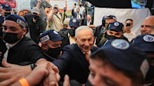 Israeli Prime Minister Benjamin Netanyahu greets supporters at a Tel Aviv market.