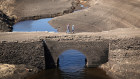 Low water levels at Baitings Reservoir reveal an ancient pack horse bridge as during last year’s drought in the UK.