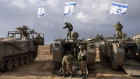 Israeli soldiers work on armoured military vehicles along Israel’s border with the Gaza Strip.