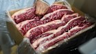 A worker checks vacuum-packed steaks ready for export at the Frigolar beef processing plant in La Plata, Argentina.