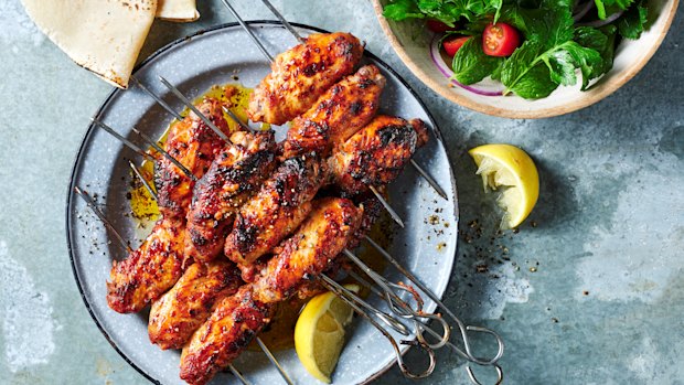 Kanat chicken wings with sumac, tomato and onion salad.