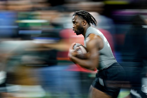 Wisconsin linebacker Maema Njongmeta runs the ball during the NFL football scouting combine in Indianapolis.