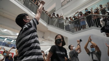 Staff applaud Chan Pui-man, right, associate publisher of Apple Daily and Lam Man-chung, executive editor-in-chief of Apple Daily after the final edition is sent to the printers. 