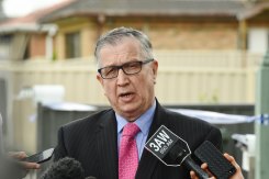 Mick Hughes briefs the media at a murder scene.