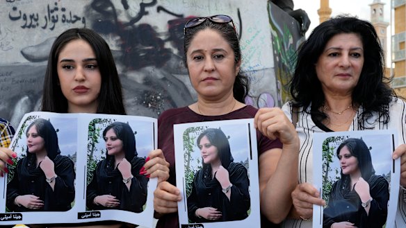 Kurdish activists hold portraits of Iranian Mahsa Amini, during a protest against her death.
