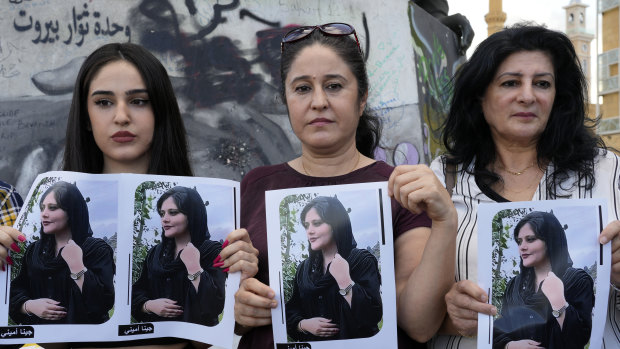 Kurdish activists hold portraits of Iranian Mahsa Amini, during a protest against her death.