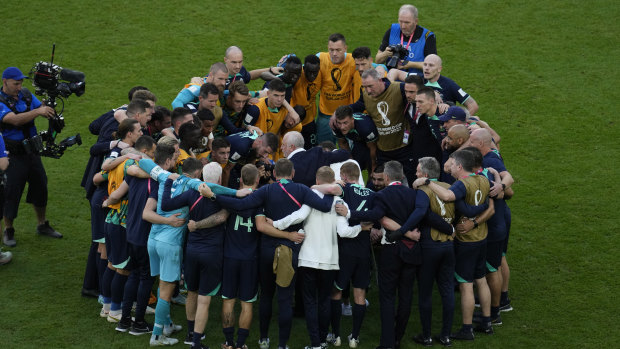 A group hug for the Socceroos after their win against Tunisia.