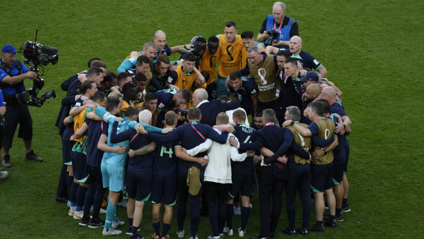 A group hug for the Socceroos after their win against Tunisia. Martin Boyle is among them.