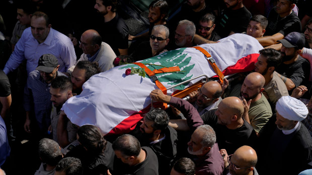 Mourners carry the body of Reuters videographer Issam Abdallah on Saturday. 
