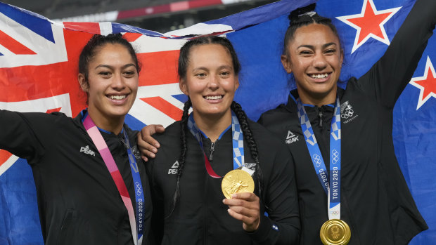 Olympic gold medallist Tyla Nathan-Wong (centre) and her teammates after winning gold at the 2020 Tokyo Olympics.