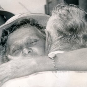 Survivors fall into each others arms in relief.