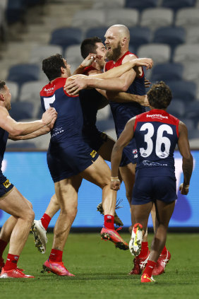 The Demons erupt after Max Gawn’s minor premiership-winning goal against Geelong.