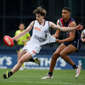 Jonty Faull gets a kick away for the Rebels during a Talent League clash with the Dragons.