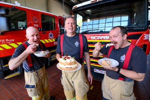 A chef in hot demand: Preston firefighter Mark Proctor, centre, serves cake to colleagues Matt Tucker, left, and Lachie Somers, right.