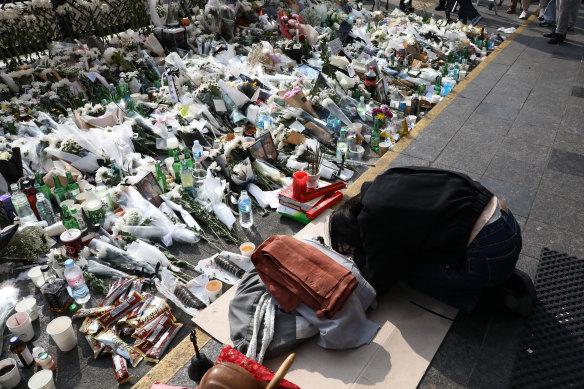 A woman pays tribute to the victims near the scene.