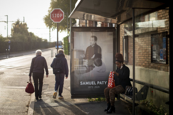 A memorial portrait of Samuel Paty at a bus stop in Conflans-Sainte-Honorine, the Paris suburb where he taught.